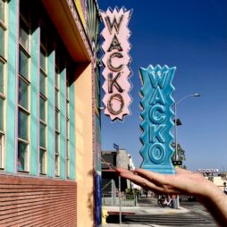front of Wacko on Hollywood boulevard with neon wacko sign in background